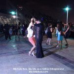 A group of people dancing at night.