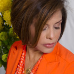 A woman wearing an orange blazer.