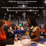 A woman talking to a man at a convention.