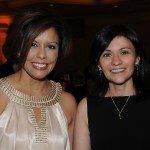 Two women standing next to each other at an event.