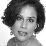 A black and white photo of a woman with short hair.