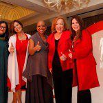 A group of women posing for a picture at a coca cola event.