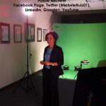 A woman standing in front of a green screen.