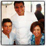 A man and woman posing for a photo with a chef.